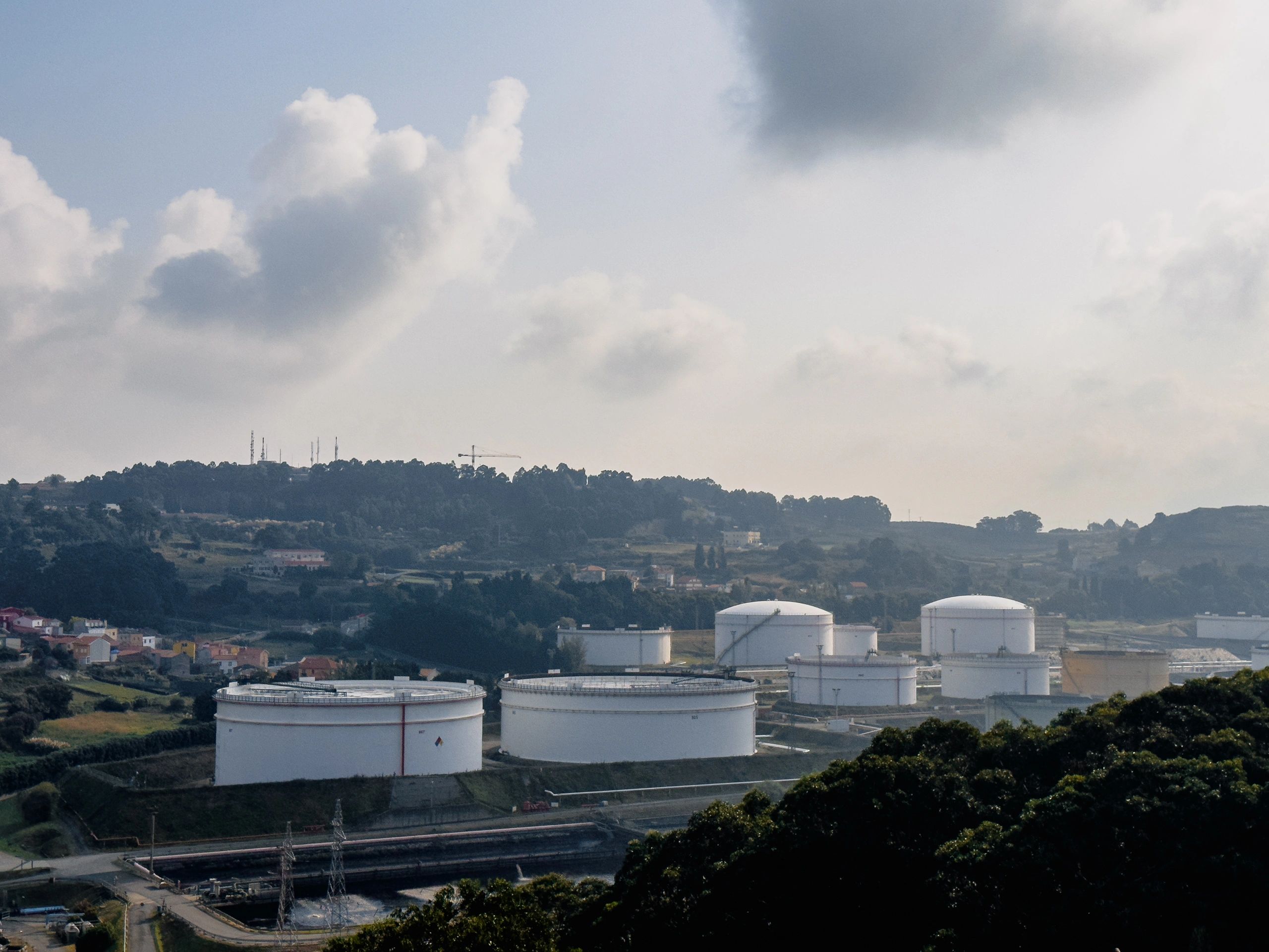 Large white petroleum storage tanks at an industrial oil depot