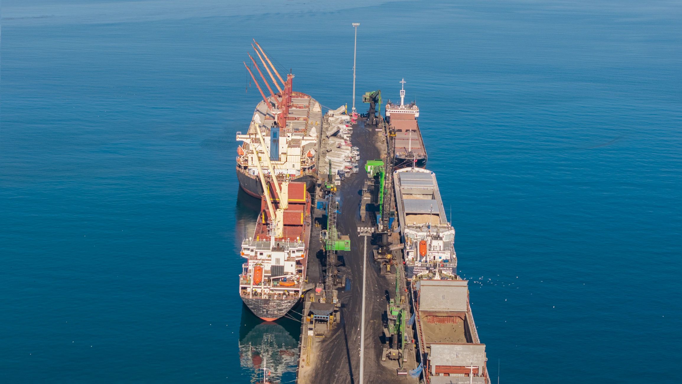 Busy cargo port illustrating coordinated sea logistics for petroleum trade