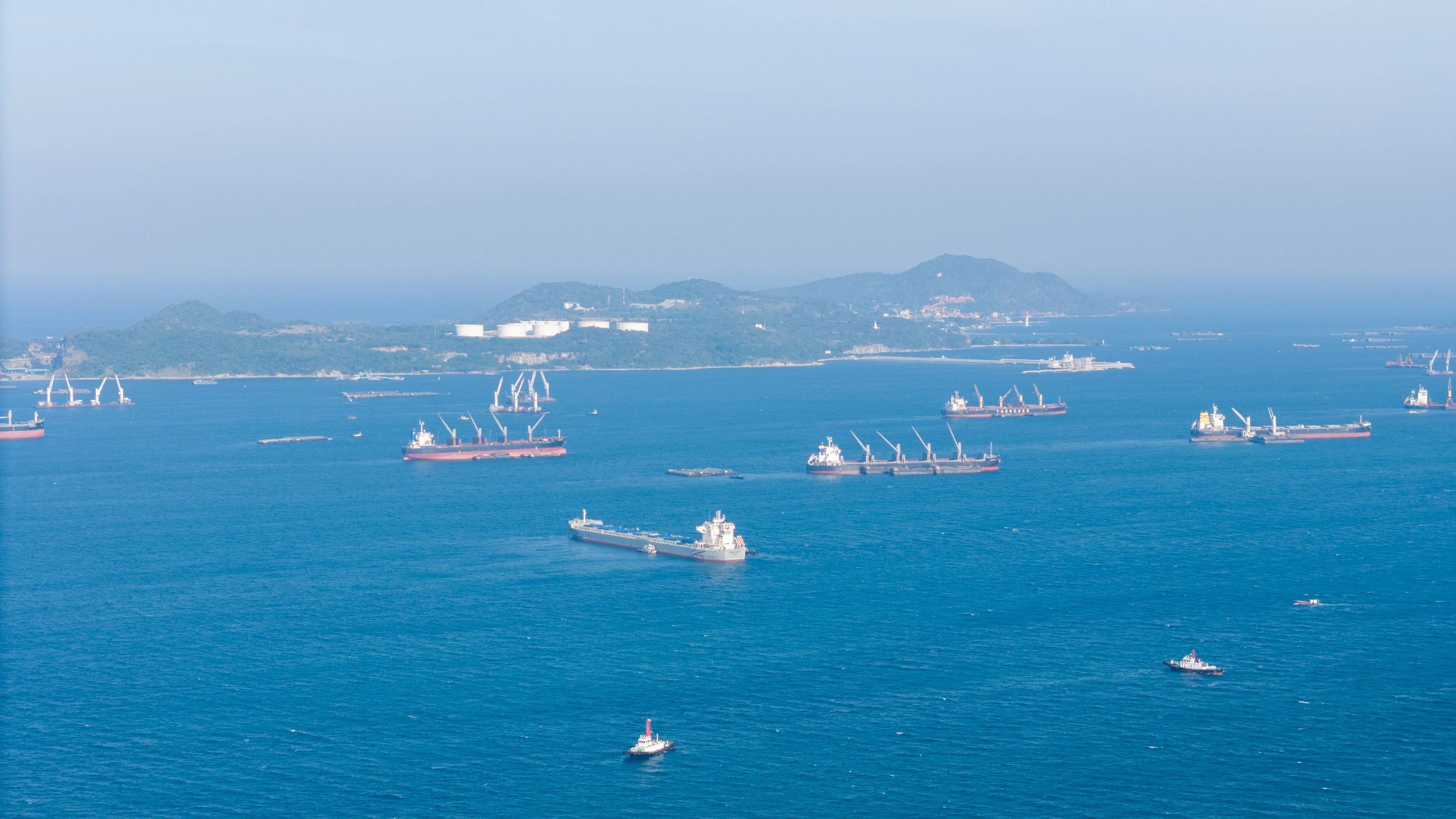 Commercial oil tankers and industrial storage facilities supporting global maritime energy trade